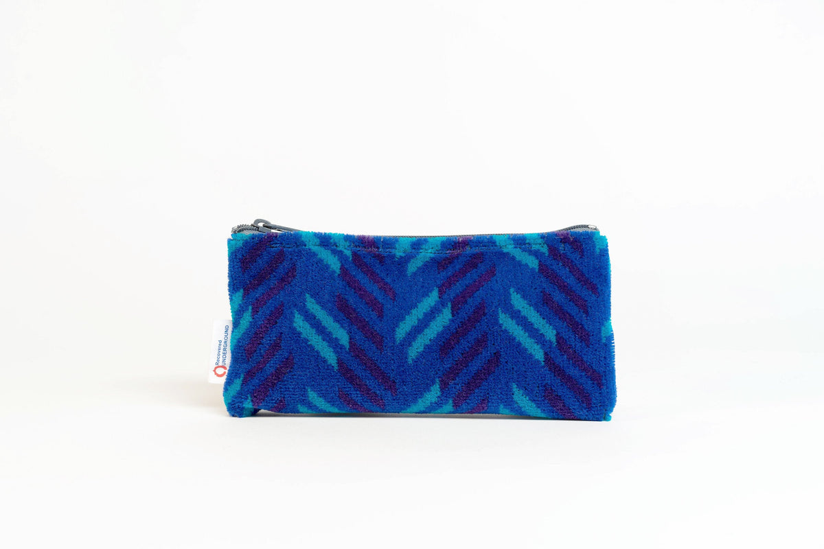 British Rail Network SouthEast Blue Blaze Moquette Pencil Case in bright blue moquette with turquoise and dark purple diagonal stripes.