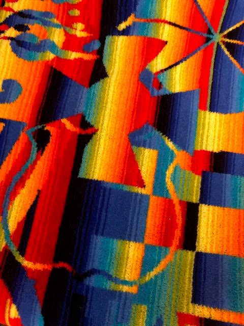 Los Angeles MultipliCity moquette fabric close-up of vibrant blue yellow orange and red design
