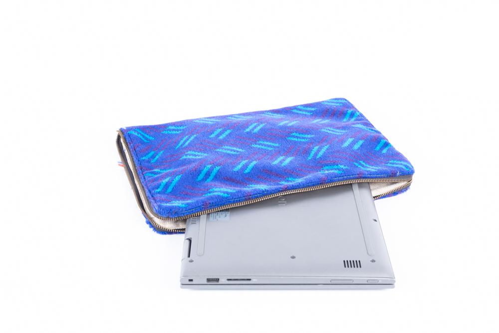 British Rail Network SouthEast Blue Blaze Moquette Laptop Case in bright blue moquette with turquoise and dark purple diagonal stripes.