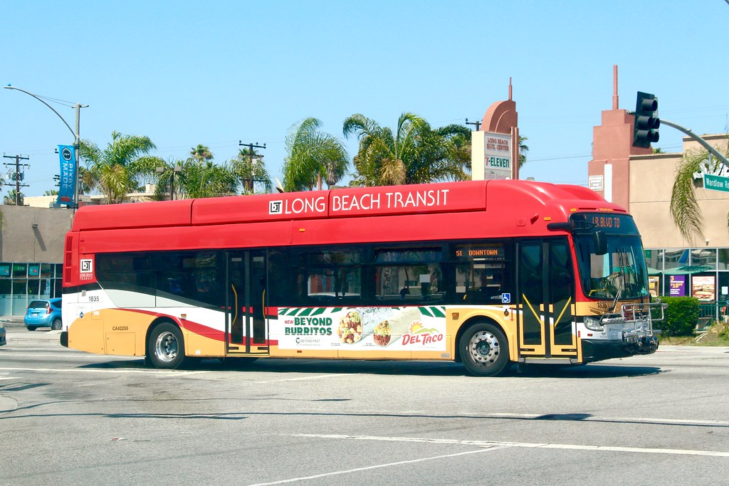 Long Beach Transit New Flyer XN40 bus exterior in red and yellow livery, shown for operator context. Photo: So Cal Metro, Flickr.