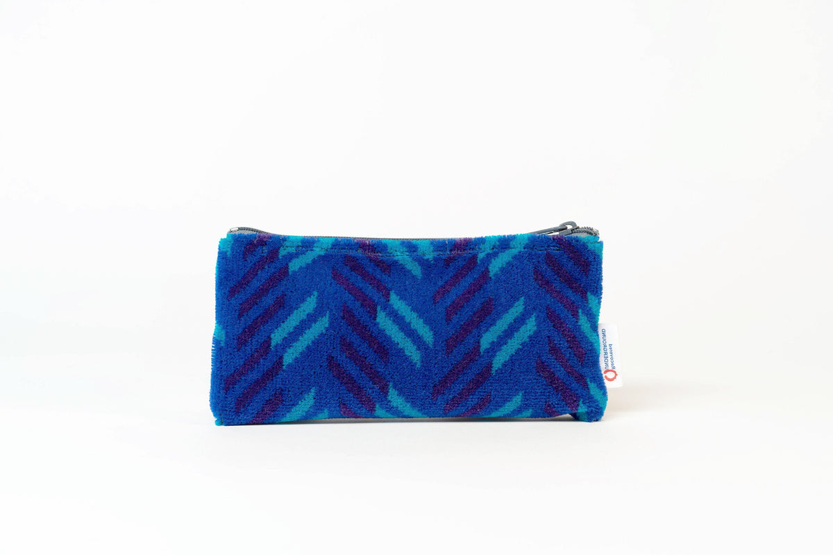 British Rail Network SouthEast Blue Blaze Moquette Pencil Case in bright blue moquette with turquoise and dark purple diagonal stripes.