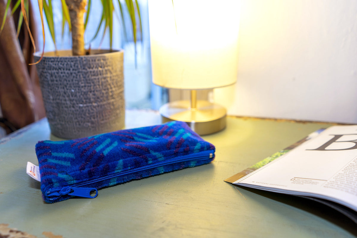 British Rail Network SouthEast Blue Blaze Moquette Pencil Case in bright blue moquette with turquoise and dark purple diagonal stripes.