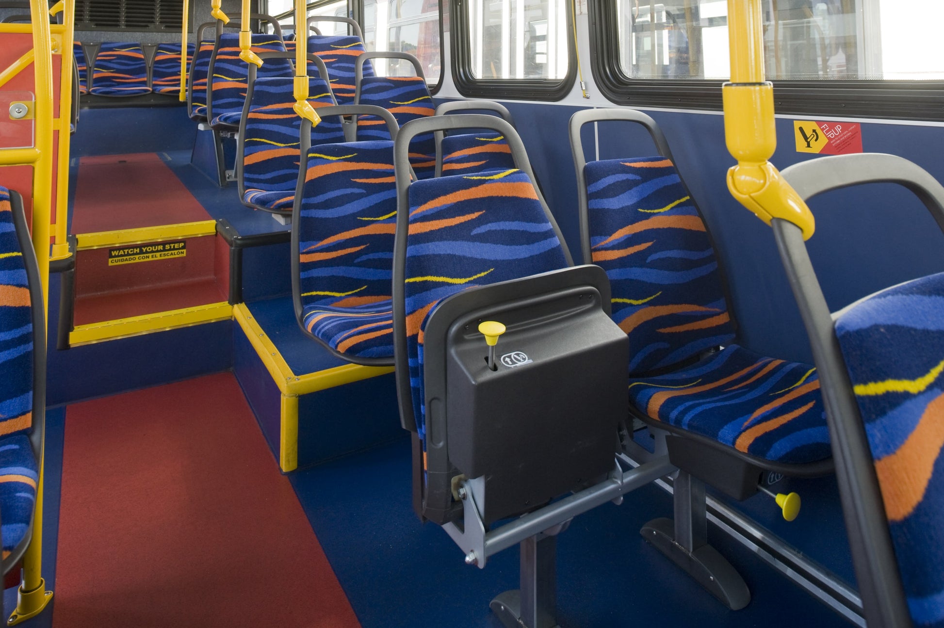 Long Beach Transit bus interior showing blue, orange and yellow wave-pattern moquette matching this fabric. Photo: American Seating, via METRO Magazine.