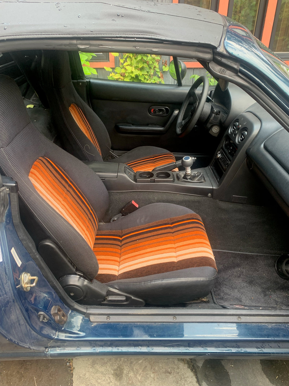 Car seat interior upholstered in Network SouthEast First Class Donkey Stripe moquette, side view