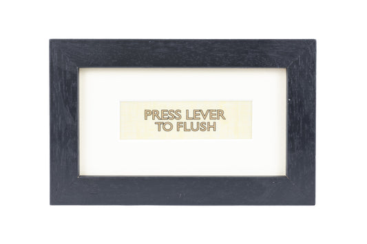 A black frame with a white background and a Press lever to flush gold text on a white plain print background