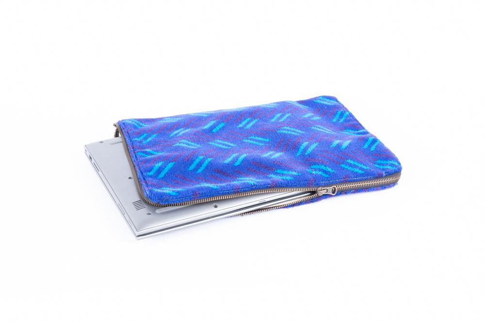 British Rail Network SouthEast Blue Blaze Moquette Laptop Case in bright blue moquette with turquoise and dark purple diagonal stripes.