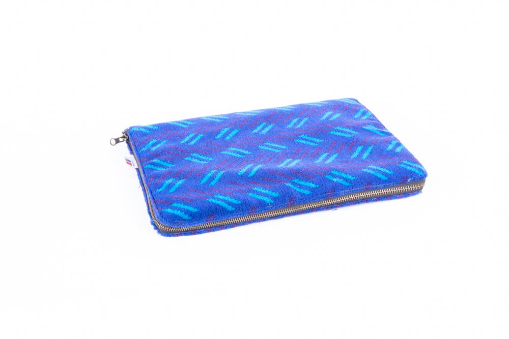 British Rail Network SouthEast Blue Blaze Moquette Laptop Case in bright blue moquette with turquoise and dark purple diagonal stripes.