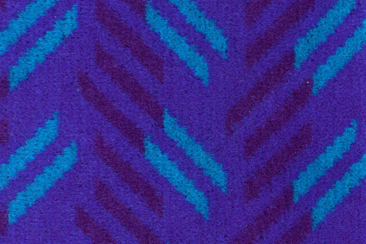 British Rail Network SouthEast Blue Blaze Moquette Laptop Case in bright blue moquette with turquoise and dark purple diagonal stripes.